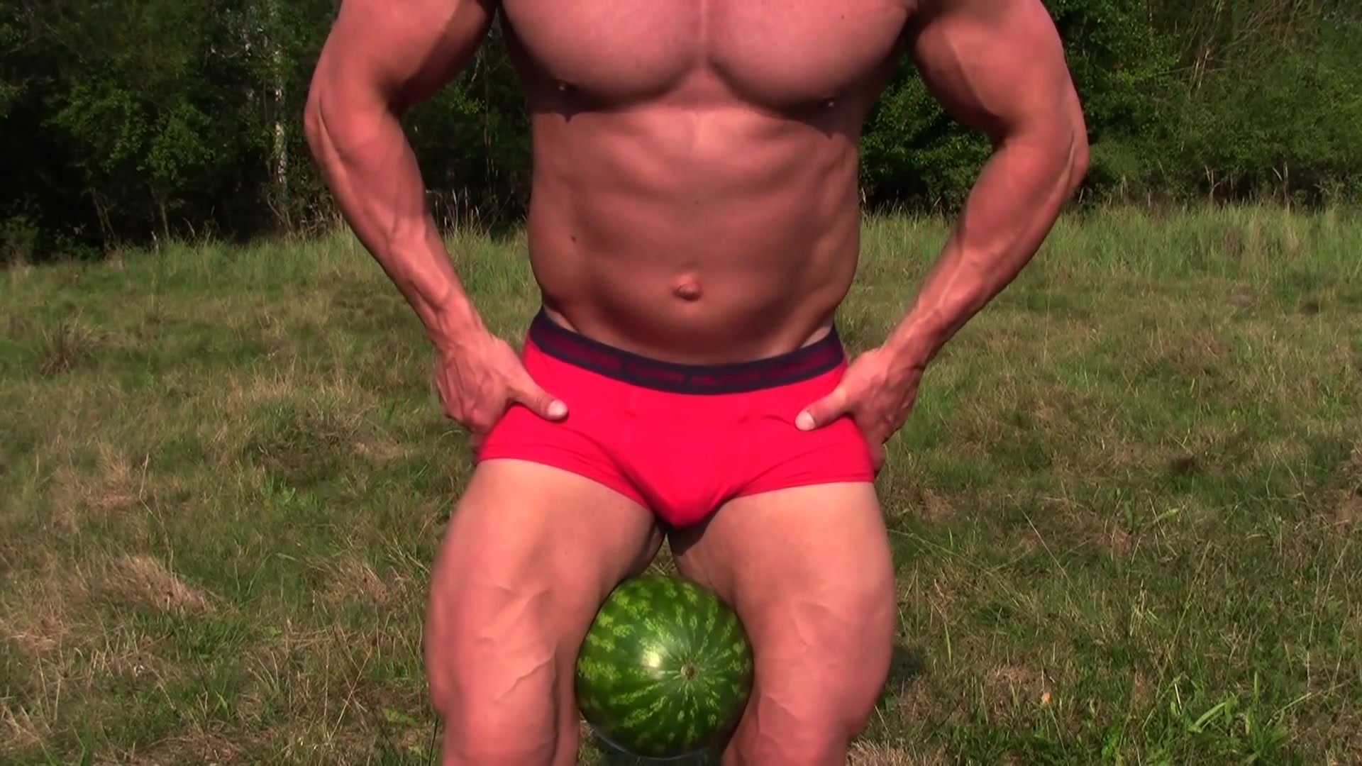 bodybuilder crushes a watermelon