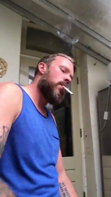 Furry and handsome smoker relaxes with a cig