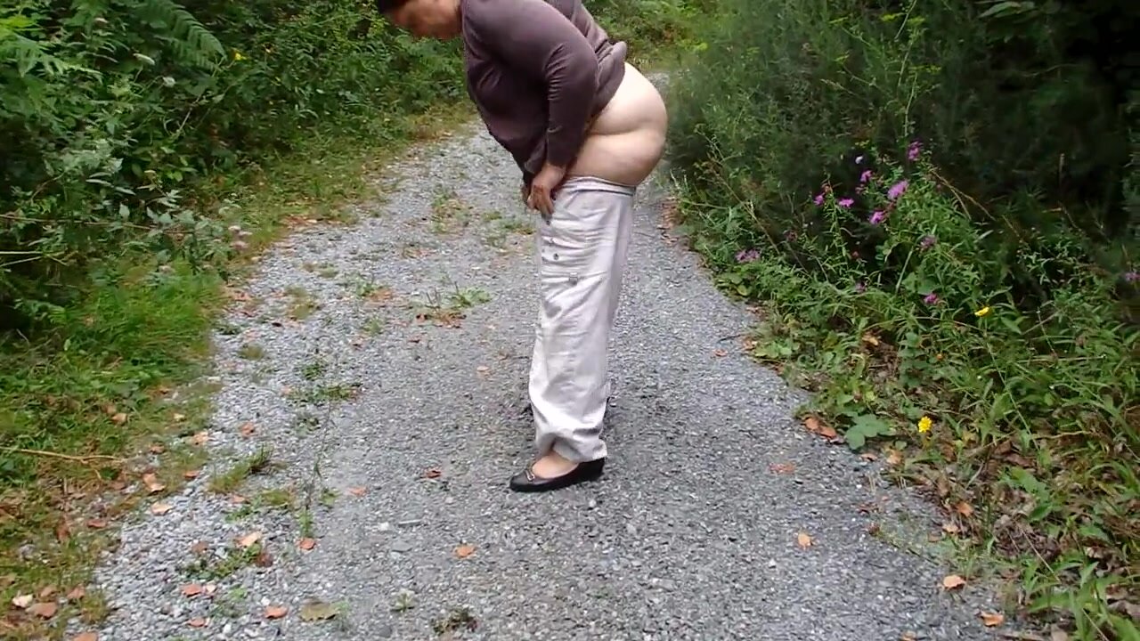 Fat amateur wife pisses on a path in the woods