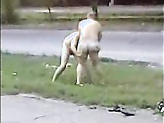 Two mature men fight naked public road side busy cars