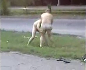 Two mature men fight naked public road side busy cars