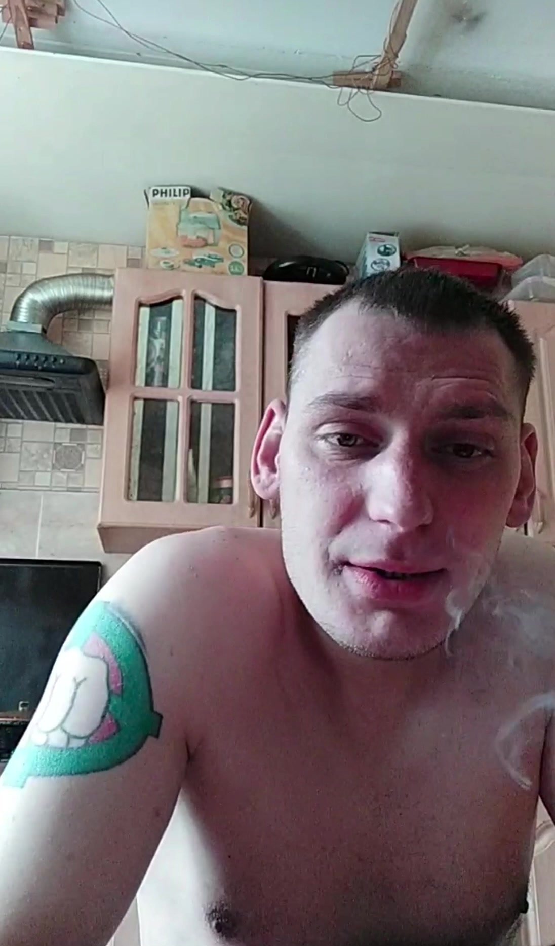 Russian naked man smoking and drinking