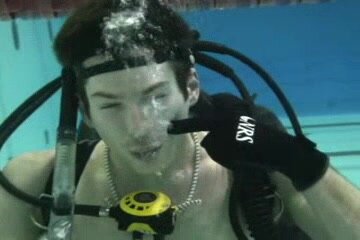 Scubadiver exhaling air barefaced underwater in pool