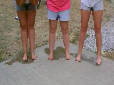 Three girls piss their shorts outside