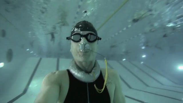 Buddies breatholding underwater in pool