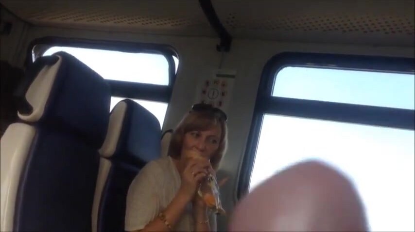 Woman opposite watches train flasher as she eats her lunch