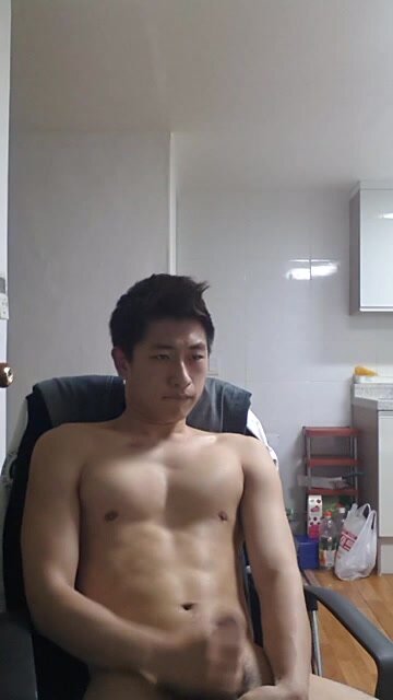 Lean, muscular Asian man strokes his cock for the camera