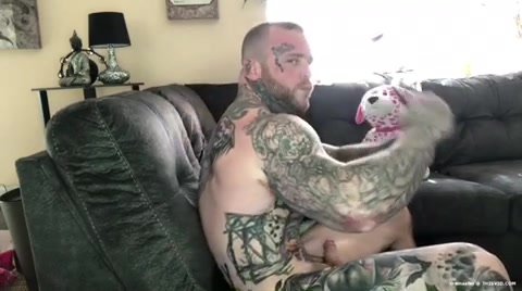 Carny-style tattooed man shows off