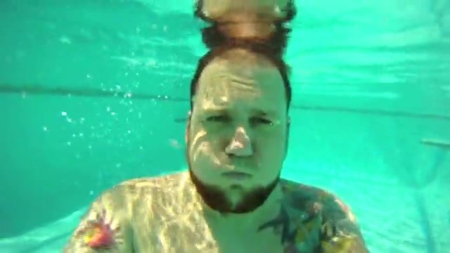 Beefy guy barefaced underwater