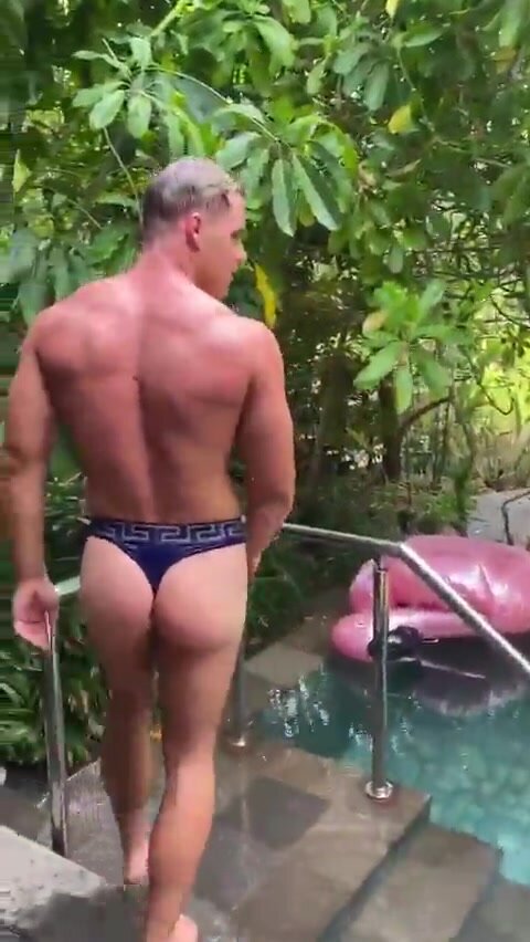 Muscle guy showering in thong