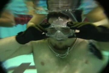 Beefy guy clearing mask underwater - video 2