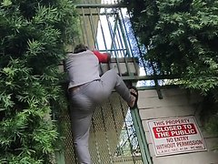 Guy with nice ass climbing gate