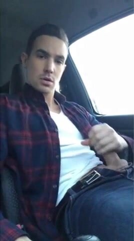 Handsome young man jacks off in a car