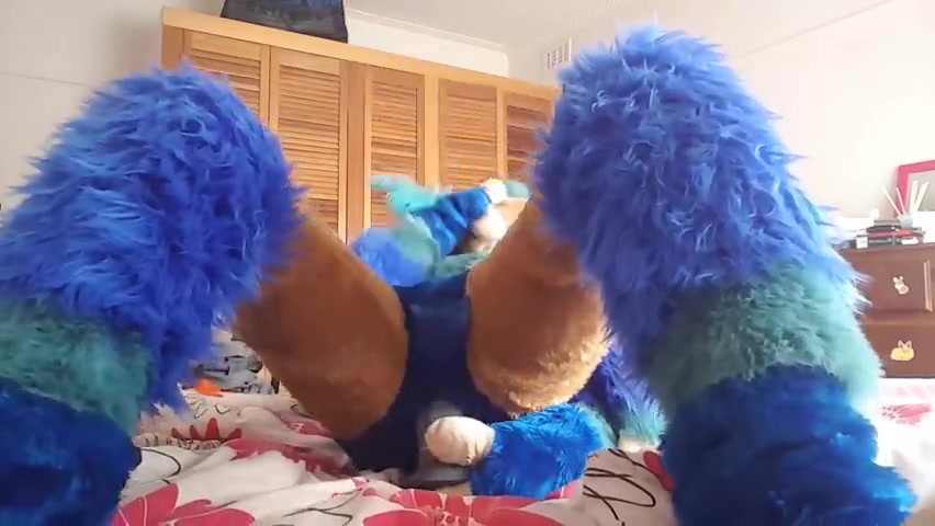 Fursuiter taking a dildo up their tight rear
