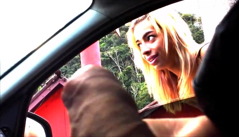 Blonde girl watches car flasher playing