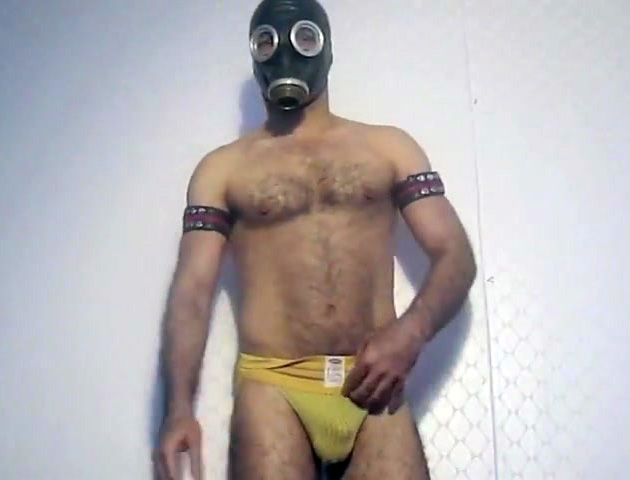 Fellow in gas mask exposing delights and rubbing cock