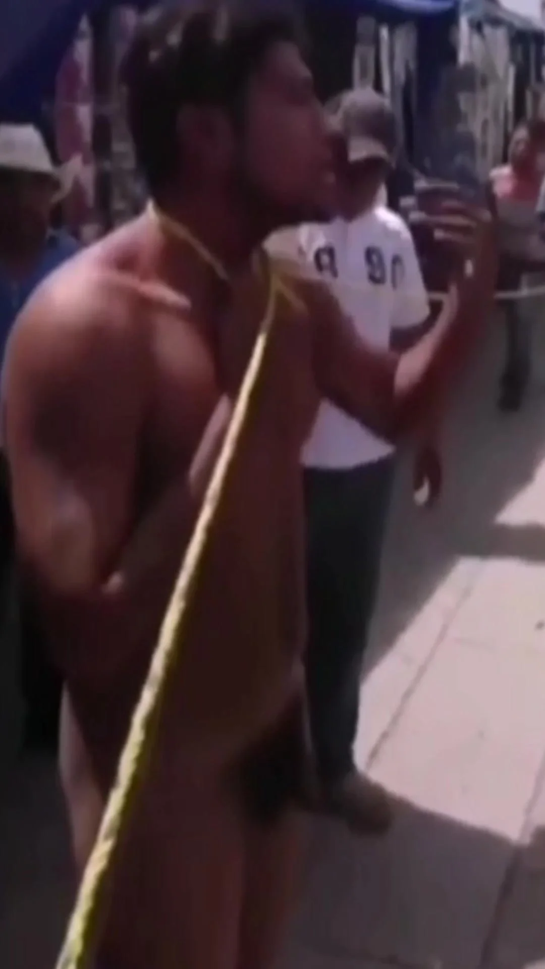 Young thief stripped naked in busy public street after