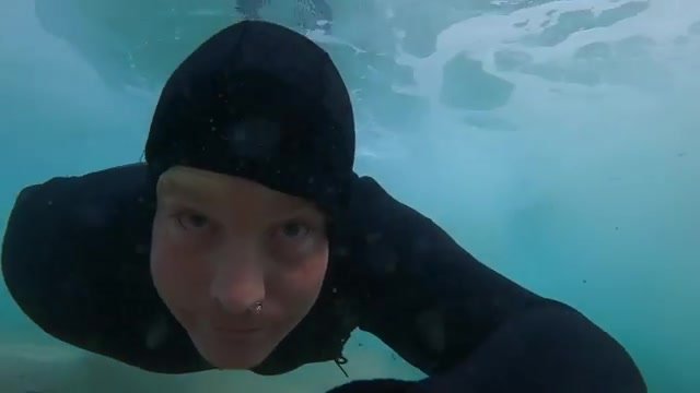 Swimming barefaced underwater in wetsuit - video 3