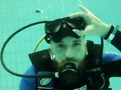 Gay scubadiver clearing his mask underwater