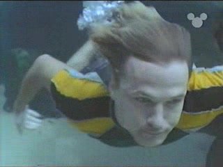 Clothed guys swimming barefaced underwater