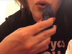 Using her buttplug to apply lipstick