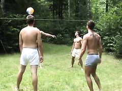 Hot young boys play strip volley ball