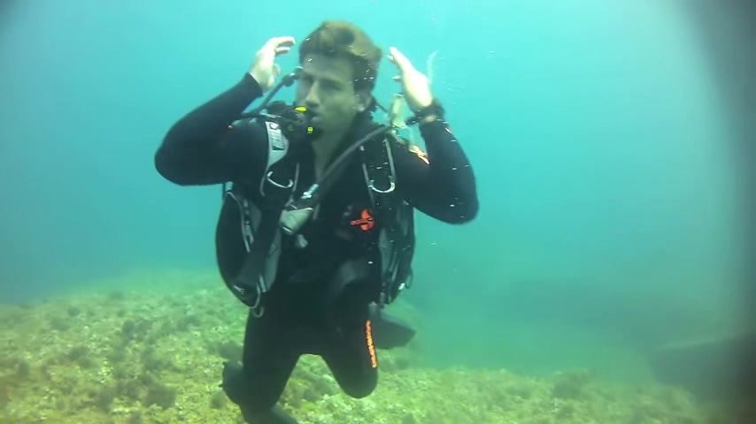 Scubadiver's underwater mask removal in sea