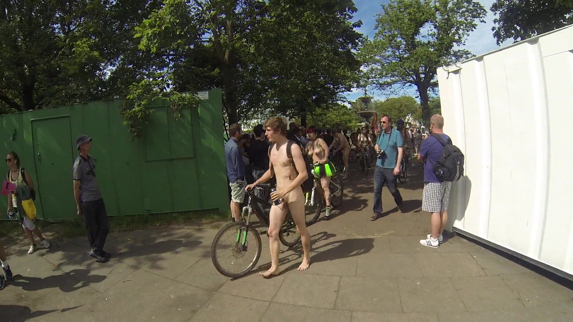 Naked man walking with bike