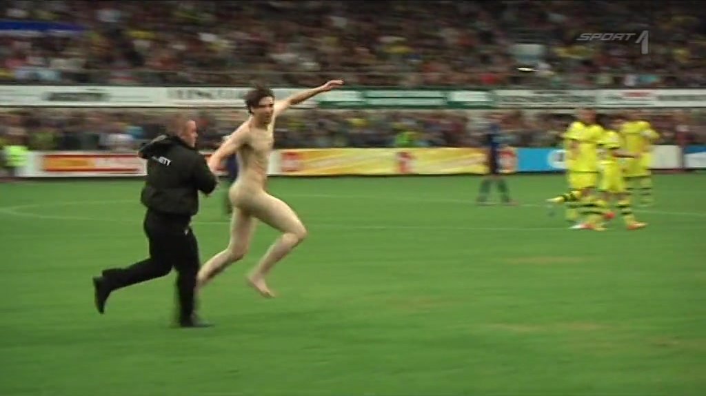 Streaker. Totally naked man runs across the pitch