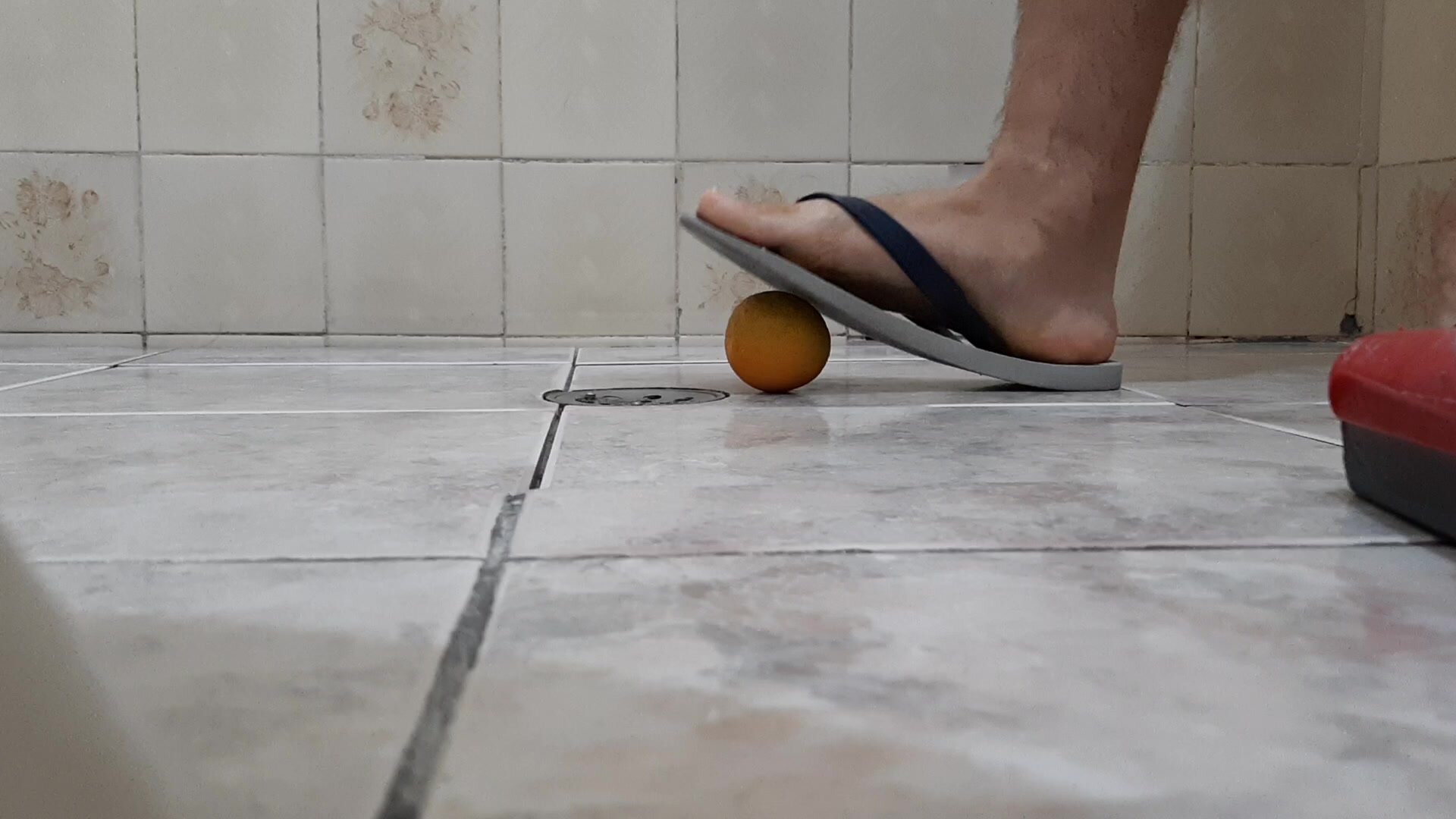 Stepping on orange with flip flop