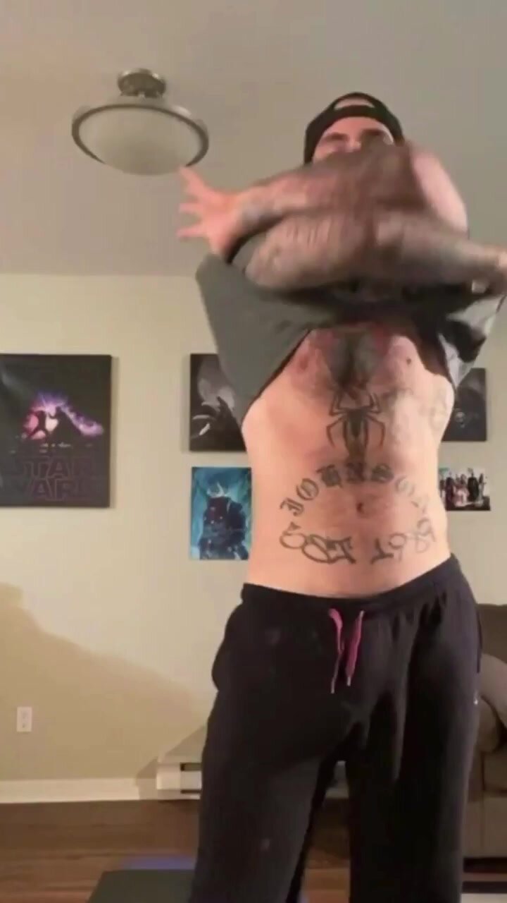 Tattooed hairy man strips