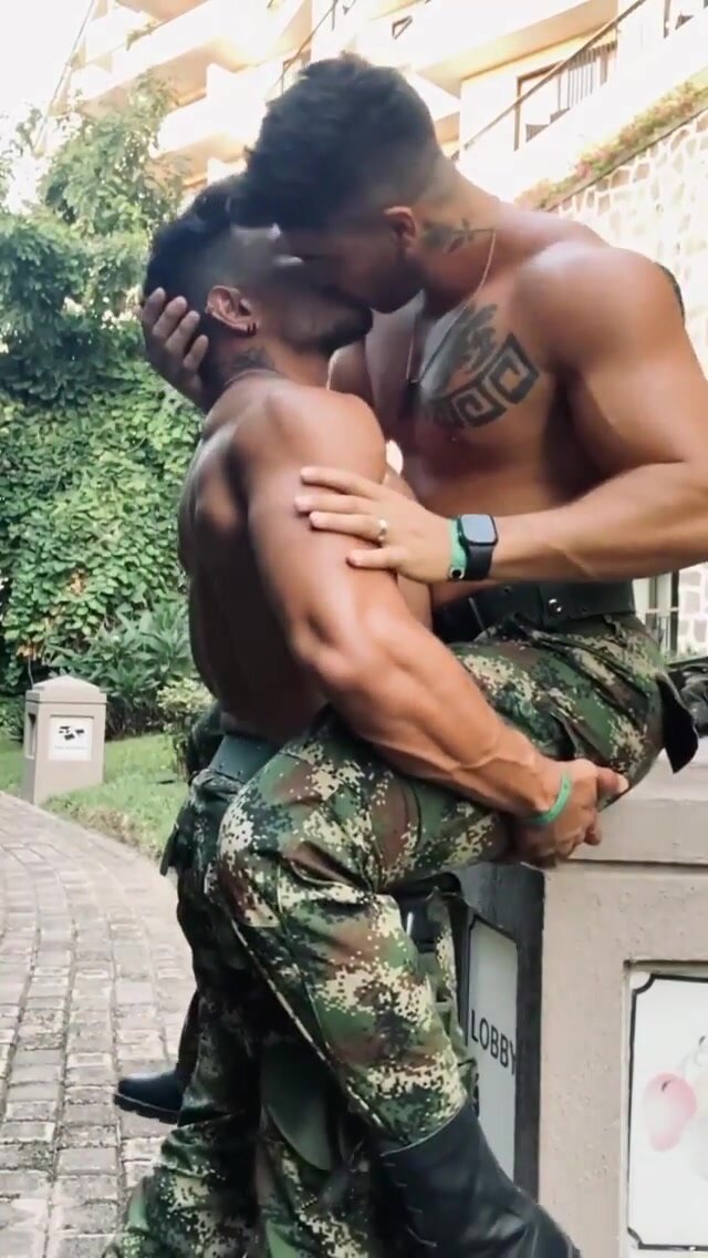 kissing couple in camouflage gear