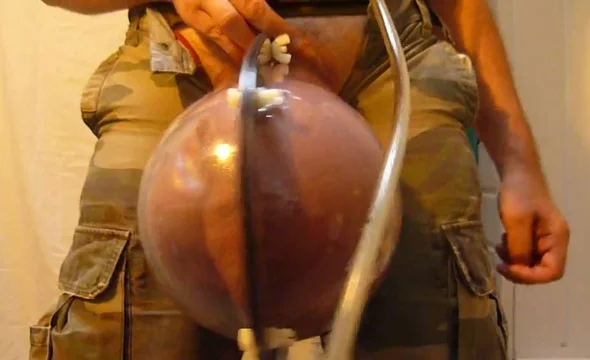 Cock and balls get huge in homemade penis pump photo