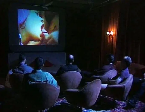 Orgy sex in an adult movie theater image