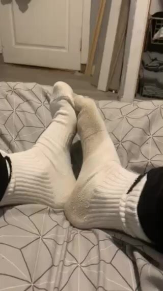 Guy shows his nike socks and feet