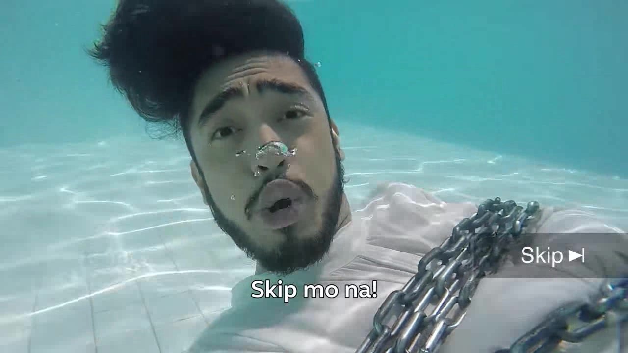Barefaced tied asian guy drowning underwater