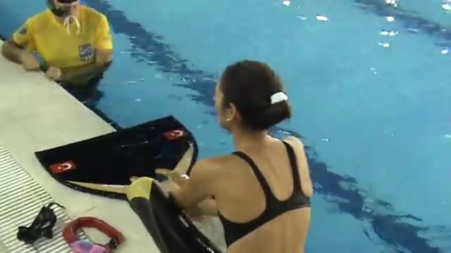 Freediver Slim Woman Take Off Monofin and Swimcap
