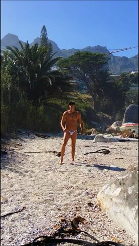 Exploring the beach in a thong