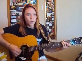 Cute girl has a sneeze atack while playing guitar