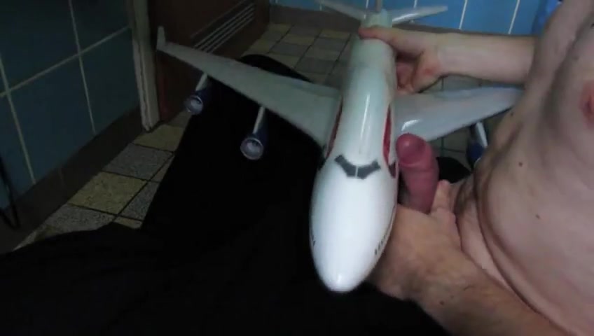 Giant man jerking with airplane