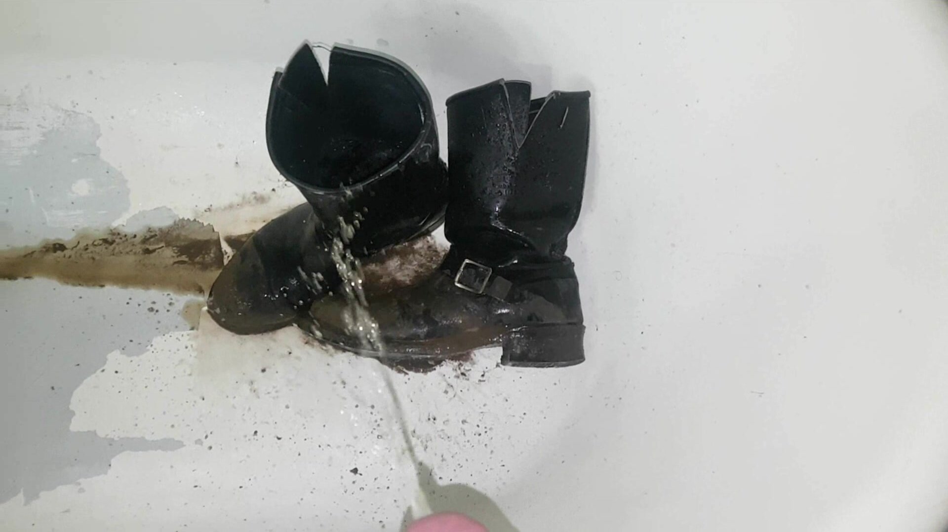 Piss-washing mud off engineer boots
