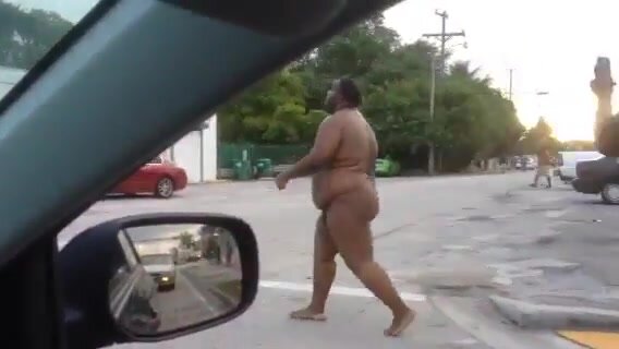 Fat black man walking naked on the street in Miami