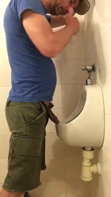 Slapping his uncut dick on the urinal