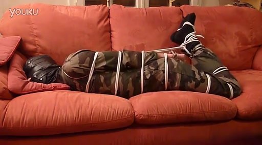 hopeless soldier hogtied on the sofa