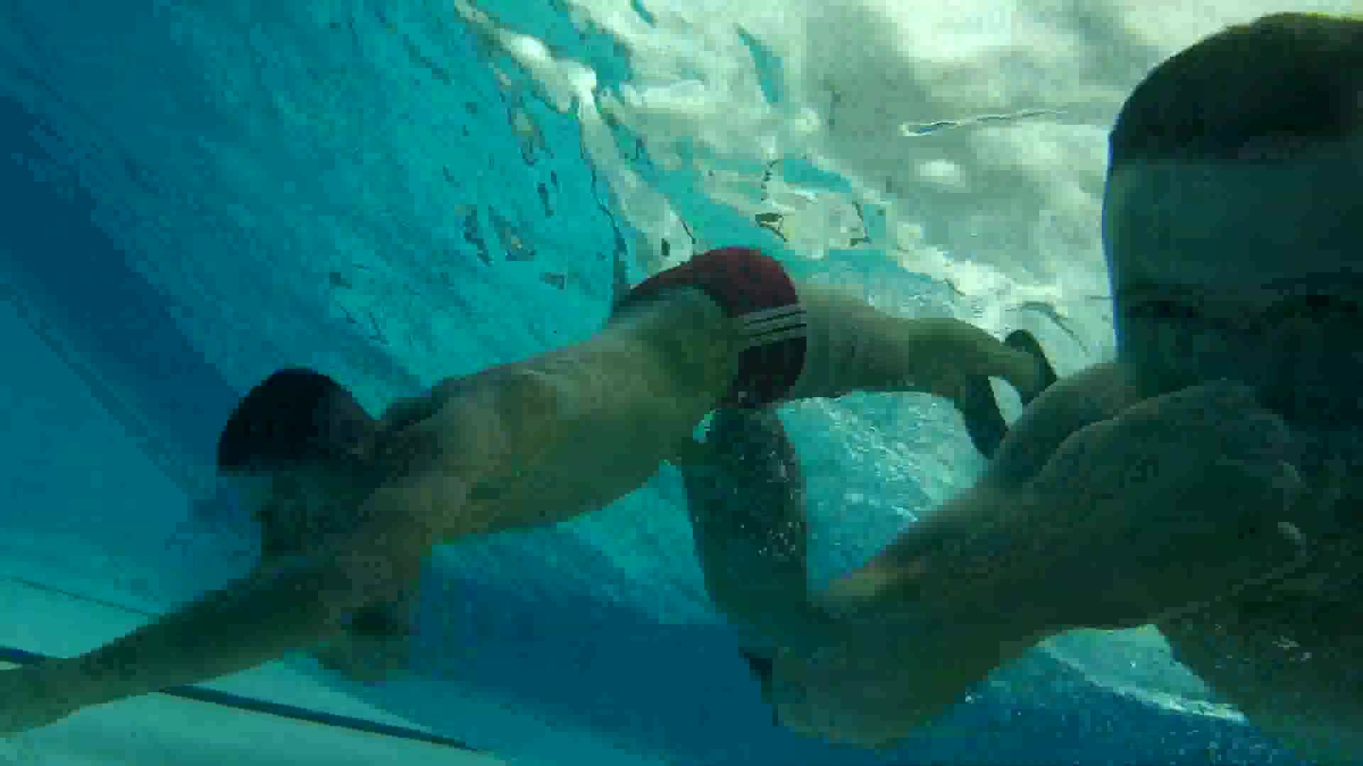 Buddies swimming barefaced underwater
