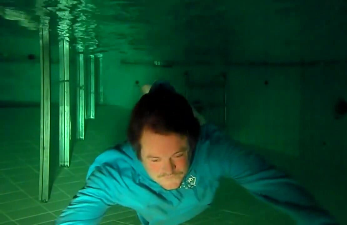 Fully clothed underwater in blue hoodie