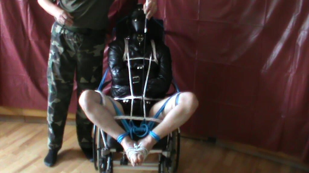 Straitjacketed slave is in wheelchair - 1
