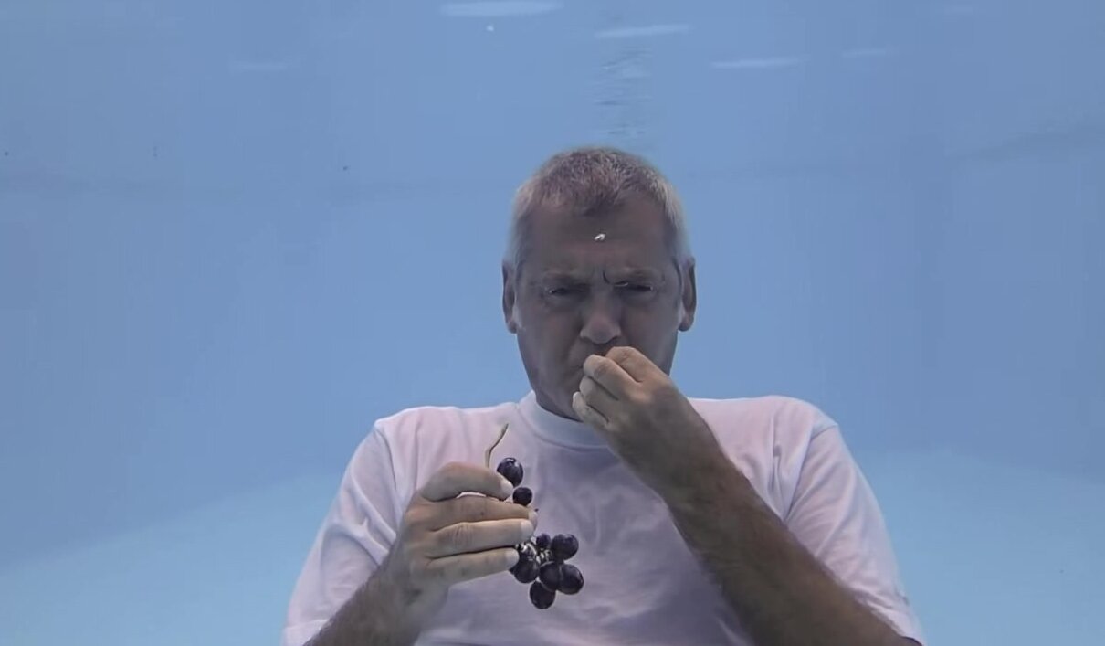 Barefaced guy eating g... underwater
