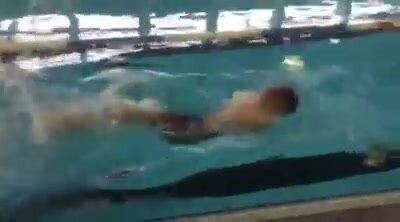 Armless triple amputee swimming