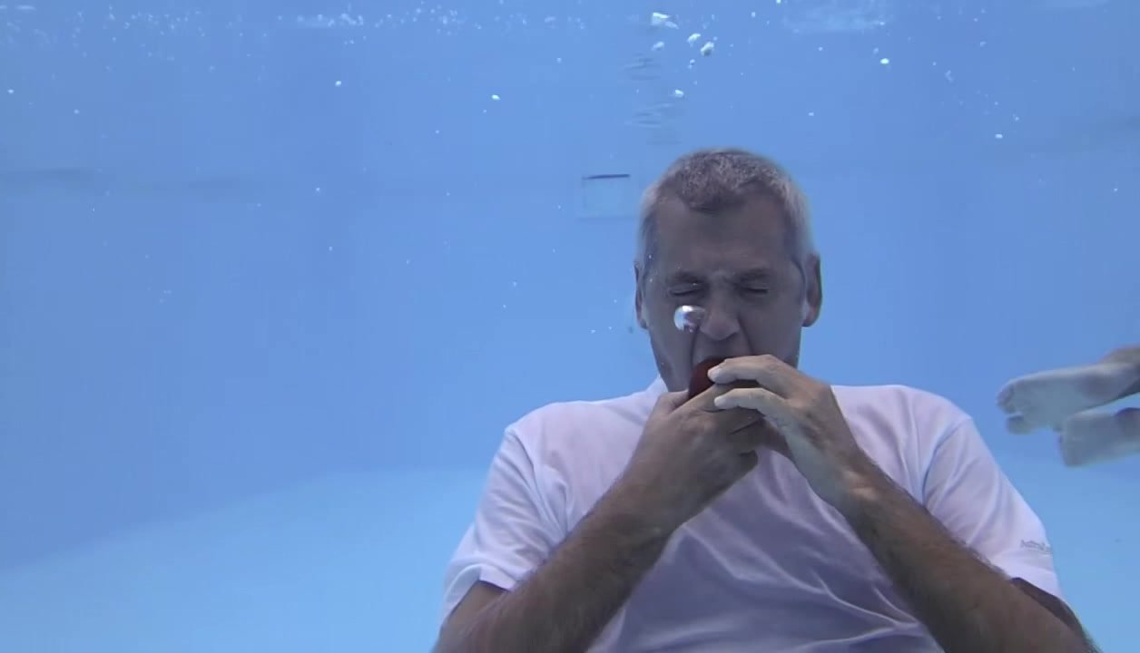 Eating apple barefaced underwater
